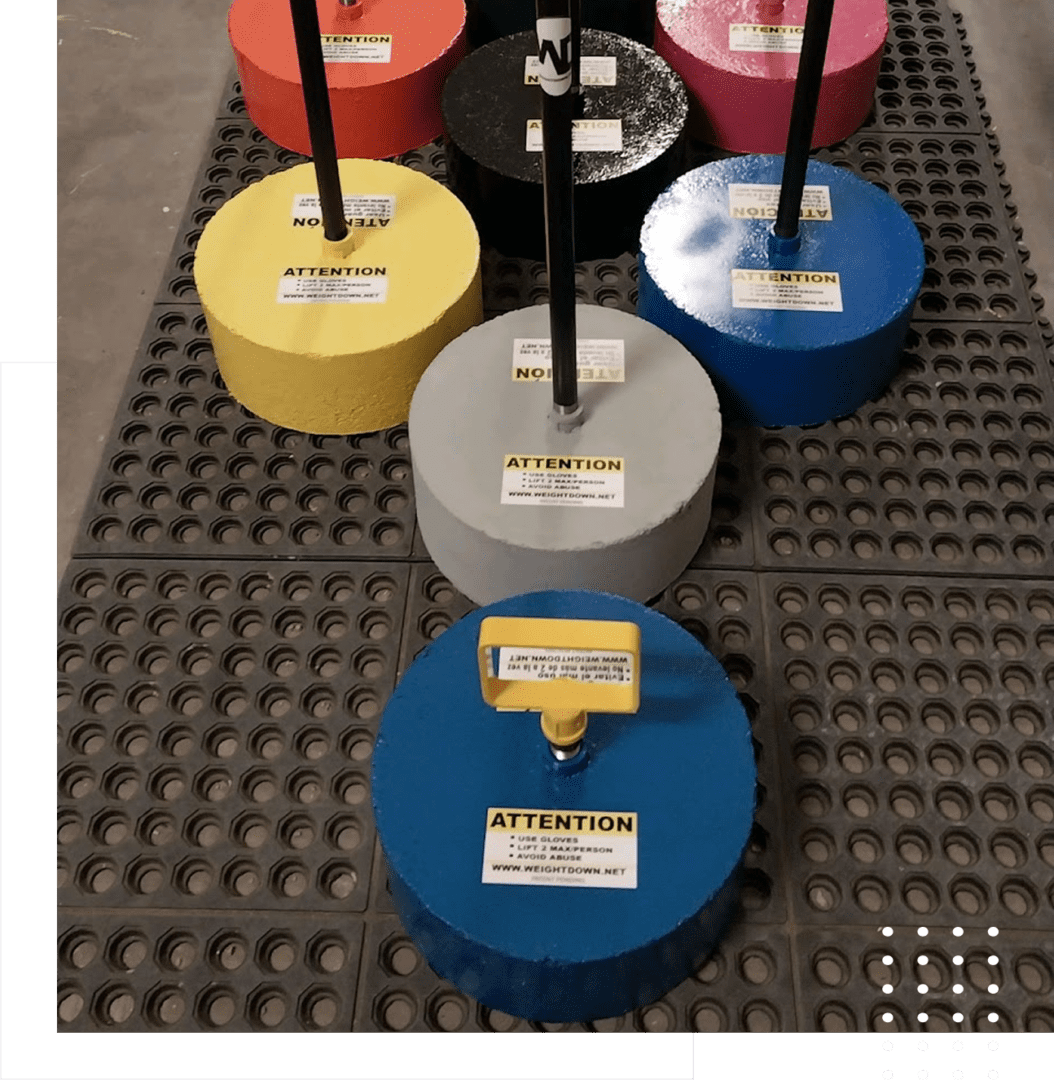 Colorful weights with attention labels on mat.